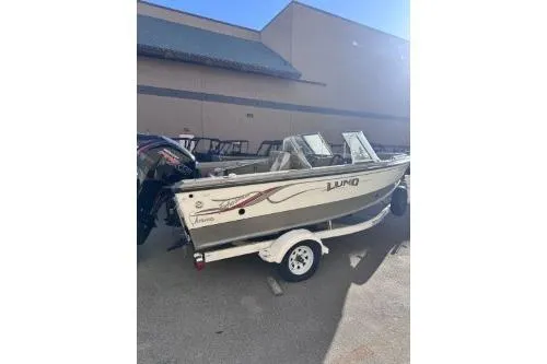 Slide: The Image of 2001 Lund 1700 Fisherman boat on trailer, parked outdoors. - 3