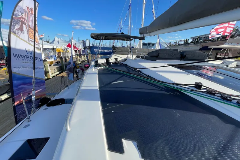 Slide: The Image of 2023 Fountaine Pajot Tanna 47 yacht at dock with banners and clear sky. - 14