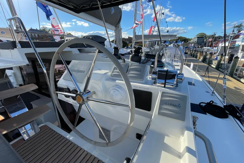 Slide: The Image of 2023 Fountaine Pajot Tanna 47 yacht helm with Garmin navigation system, docked under clear skies. - 15