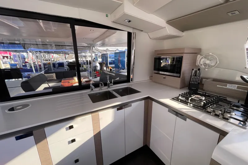 Slide: The Image of Modern kitchen interior of 2023 Fountaine Pajot Tanna 47 catamaran, featuring sleek countertops and appliances. - 4