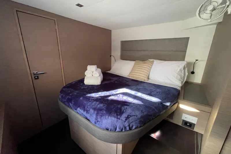 Slide: The Image of Cozy bedroom in 2023 Fountaine Pajot Tanna 47 yacht with plush bedding and modern decor. - 7