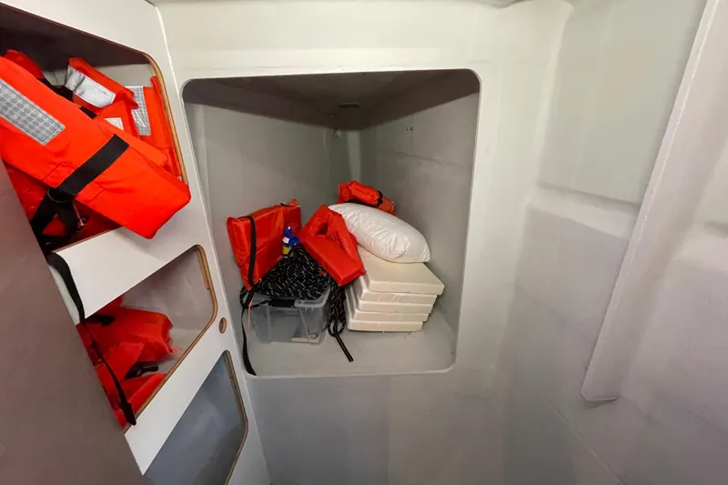 Slide: The Image of Storage area in 2023 Fountaine Pajot Tanna 47 with life jackets and supplies. - 9