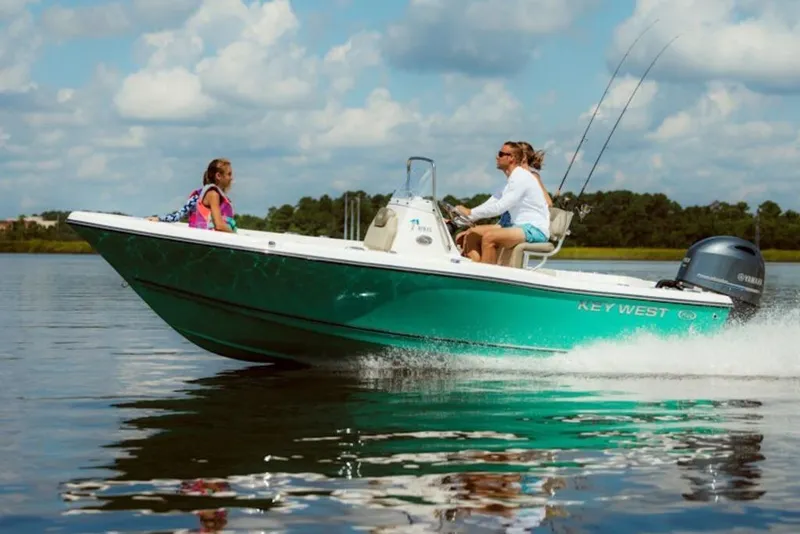 The Image of 2026 Key West 179 FS boat cruising on a calm lake under a cloudy sky. - 1