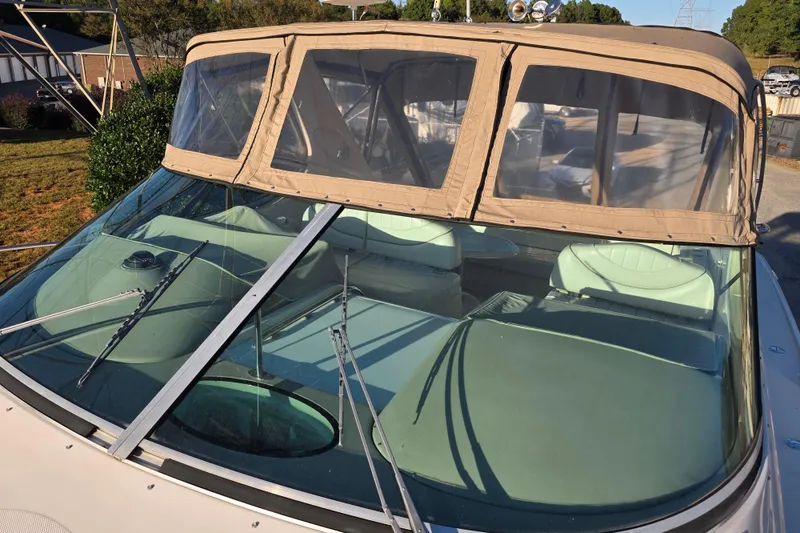 Slide: The Image of 1998 Maxum 3700 SCR boat with tan canopy and windshield wipers. - 12