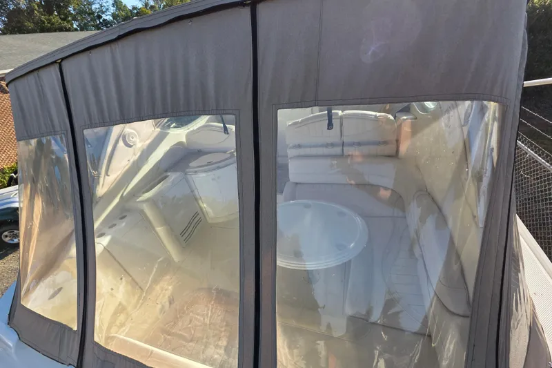 Slide: The Image of 1998 Maxum 3700 SCR boat interior with protective cover and visible seating area. - 13