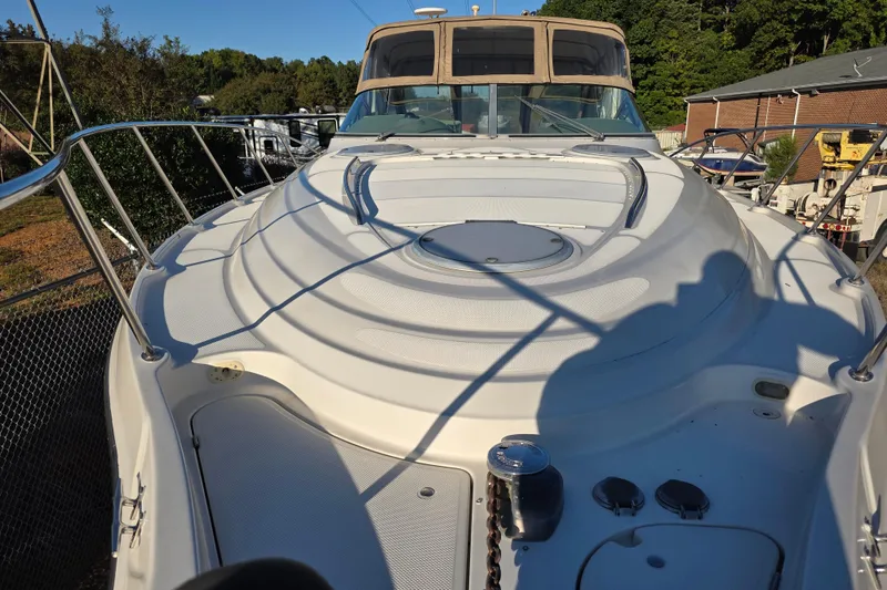 Slide: The Image of 1998 Maxum 3700 SCR yacht deck with railings and hatch, docked outdoors. - 14