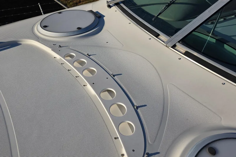 Slide: The Image of 1998 Maxum 3700 SCR boat deck with textured surface and circular hatch. - 16