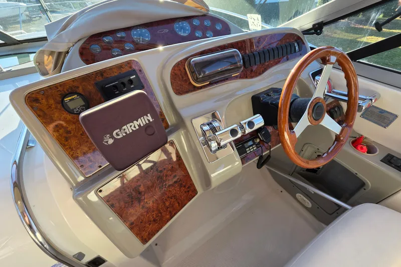Slide: The Image of 1998 Maxum 3700 SCR boat dashboard with Garmin navigation system and wooden steering wheel. - 20