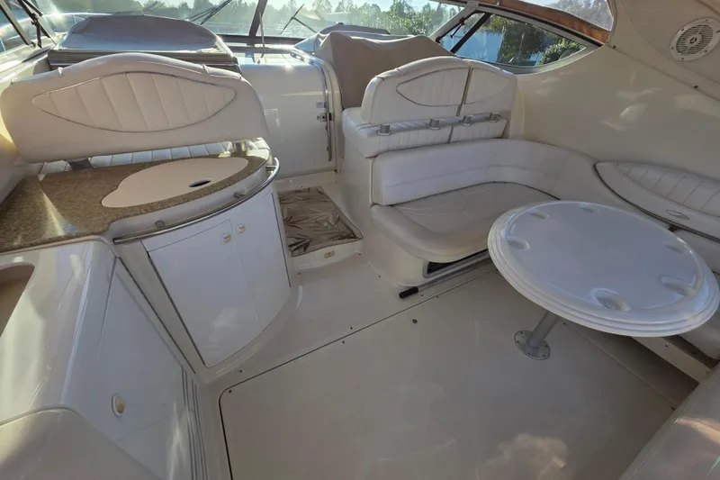 Slide: The Image of 1998 Maxum 3700 SCR yacht interior with white seating and table. - 21