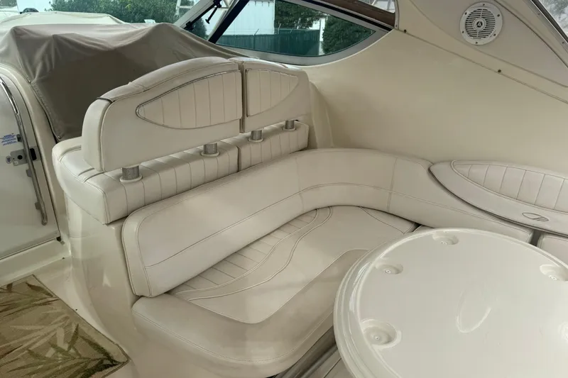 Slide: The Image of 1998 Maxum 3700 SCR boat interior with white leather seating and round table. - 23