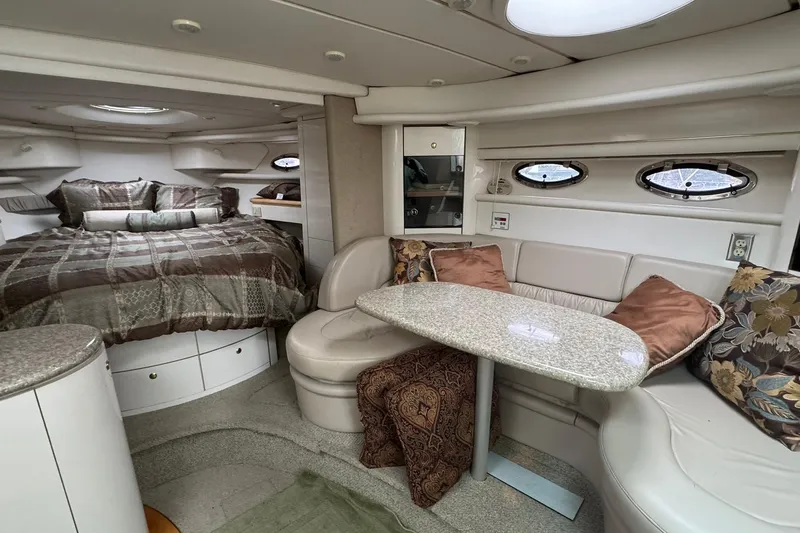 Slide: The Image of Luxurious interior of 1998 Maxum 3700 SCR yacht with cozy seating and elegant bedding. - 30