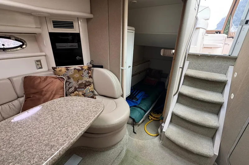 Slide: The Image of Interior of 1998 Maxum 3700 SCR yacht with seating, table, and stairs. - 32