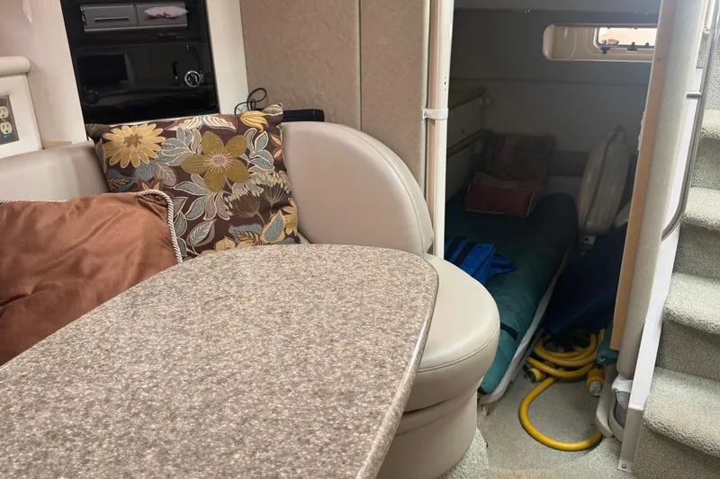 Slide: The Image of Interior of 1998 Maxum 3700 SCR boat with cozy seating and floral cushions. - 37