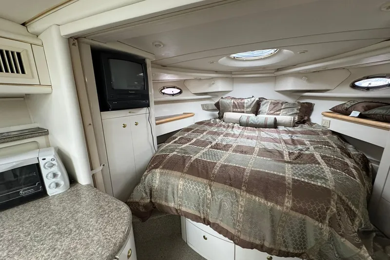 Slide: The Image of 1998 Maxum 3700 SCR cabin interior with bed, TV, and microwave. - 41