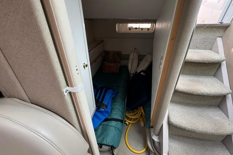 Slide: The Image of Interior of 1998 Maxum 3700 SCR boat with storage area and carpeted stairs. - 44