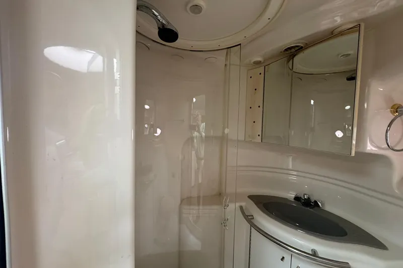 Slide: The Image of 1998 Maxum 3700 SCR yacht bathroom with shower, sink, and mirrored cabinet. - 49