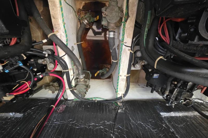Slide: The Image of Engine compartment of a 1998 Maxum 3700 SCR boat with visible hoses and wiring. - 53