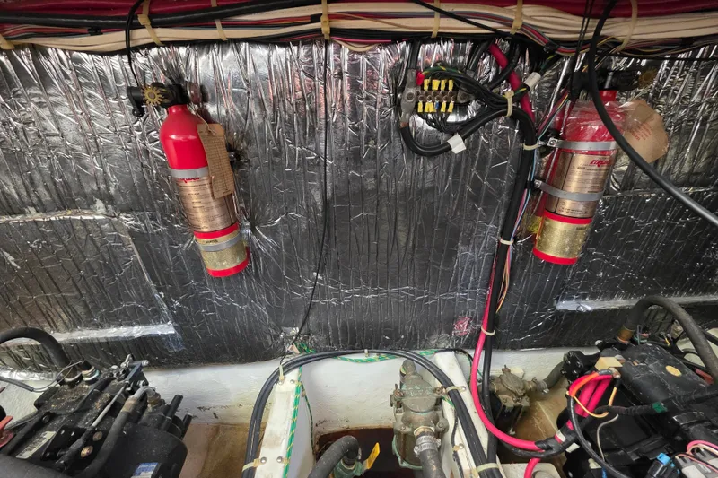 Slide: The Image of Engine room of 1998 Maxum 3700 SCR with fire extinguishers and wiring. - 54