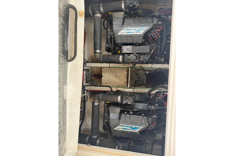 Slide: The Image of Engine compartment of a 1998 Maxum 3700 SCR boat, featuring dual MerCruiser engines. - 59