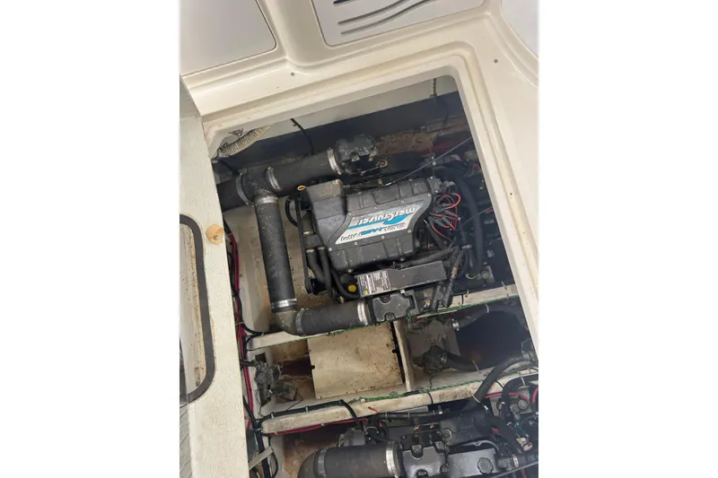 Slide: The Image of Engine compartment of a 1998 Maxum 3700 SCR boat, featuring a MerCruiser engine. - 60