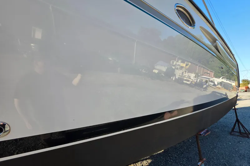 Slide: The Image of 1998 Maxum 3700 SCR boat hull with reflective surface in outdoor setting. - 7