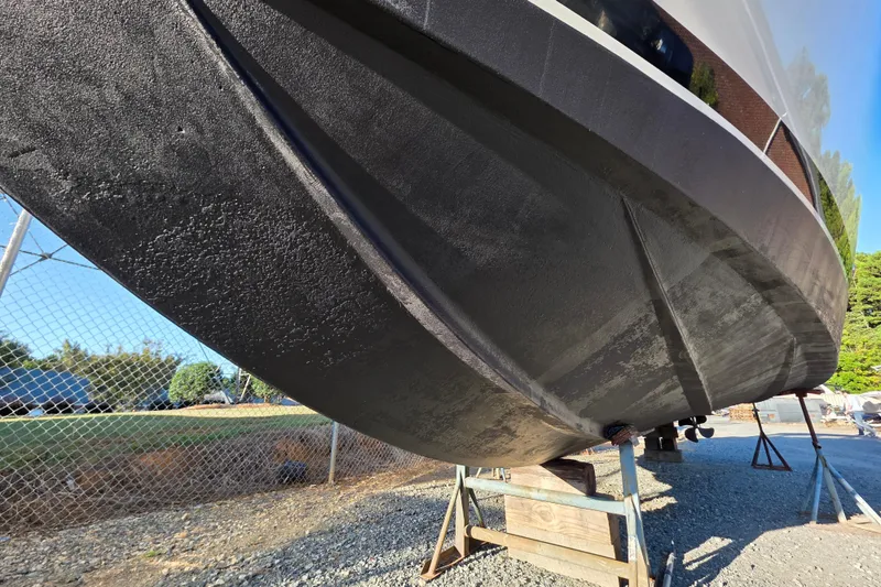 Slide: The Image of 1998 Maxum 3700 SCR boat hull on stands, outdoor storage area. - 8