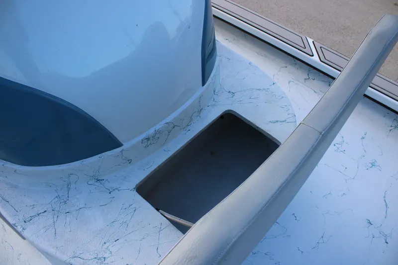 Slide: The Image of 2024 Shoalwater 23 Catamaran interior detail with storage compartment and marbled design. - 10