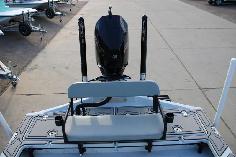 Slide: The Image of 2024 Shoalwater 23 Catamaran rear view with motor and seating on display. - 12