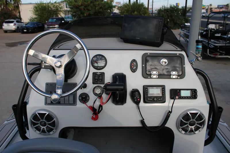 Slide: The Image of Dashboard of 2024 Shoalwater 23 Catamaran with steering wheel and electronic controls. - 13