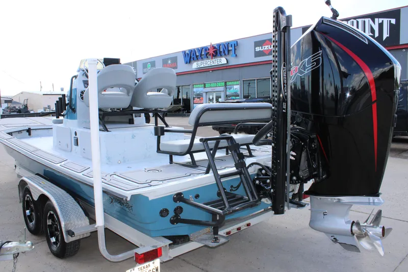 Slide: The Image of 2024 Shoalwater 23 Catamaran with powerful outboard motor on trailer at dealership. - 3