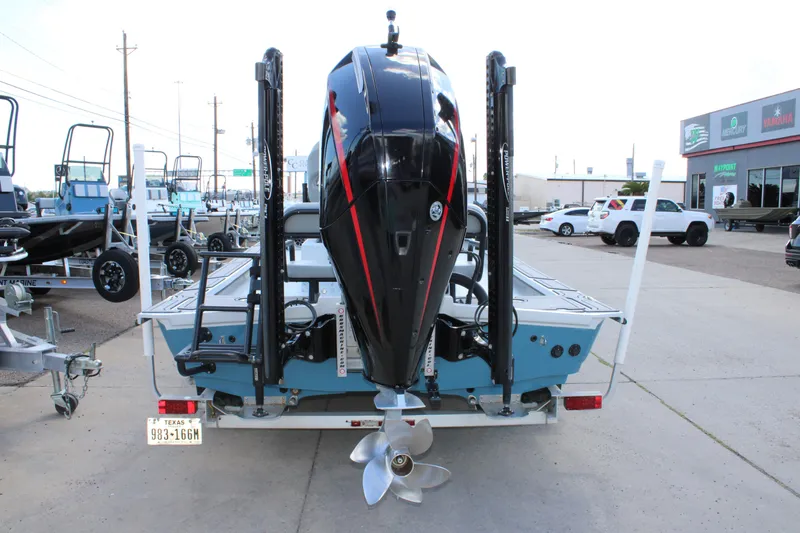 Slide: The Image of 2024 Shoalwater 23 Catamaran with powerful outboard motor, displayed at a dealership. - 7