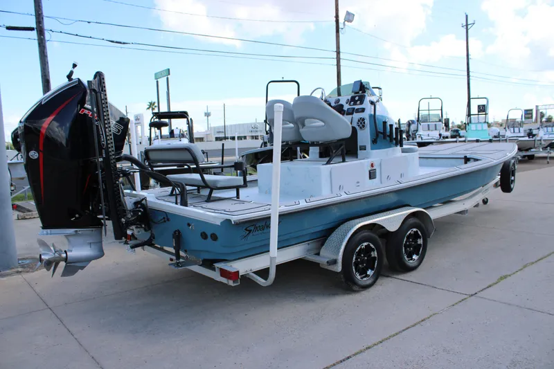 Slide: The Image of 2024 Shoalwater 23 Catamaran on trailer, featuring powerful outboard motor. - 8