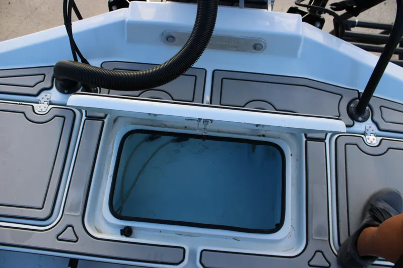 Slide: The Image of 2024 Shoalwater 23 Catamaran deck with storage compartment and non-slip surface. - 9