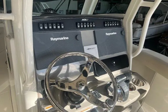 Slide: The Image of 2017 Boston Whaler 280 Outrage boat with foldable rear seating and dual Mercury engines. - 10