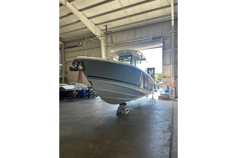 Slide: The Image of 2017 Boston Whaler 280 Outrage boat covered in protective wrap, stored outdoors. - 2