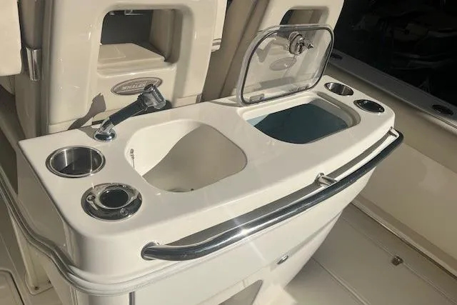 Slide: The Image of 2017 Boston Whaler 280 Outrage with dual outboard engines in a garage setting. - 30