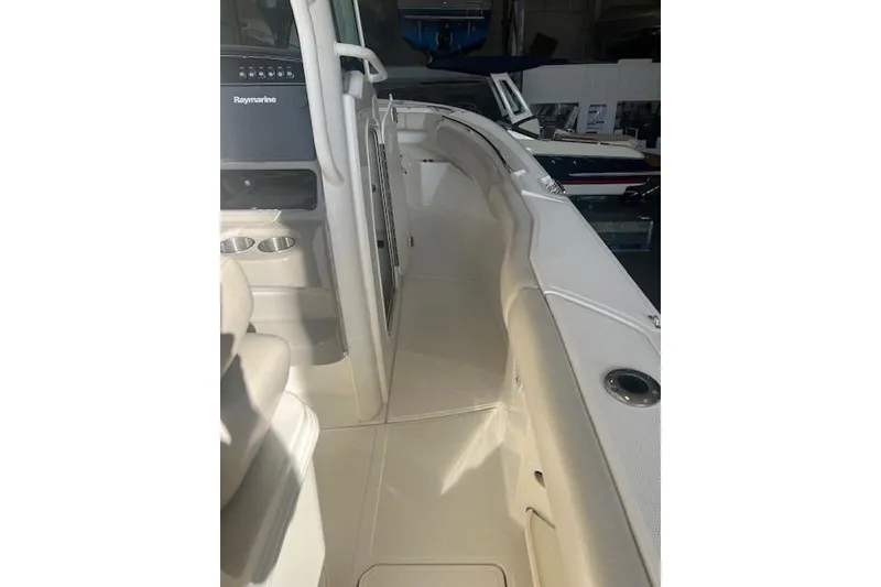 Slide: The Image of 2017 Boston Whaler 280 Outrage boat in storage, featuring dual Mercury engines. - 7