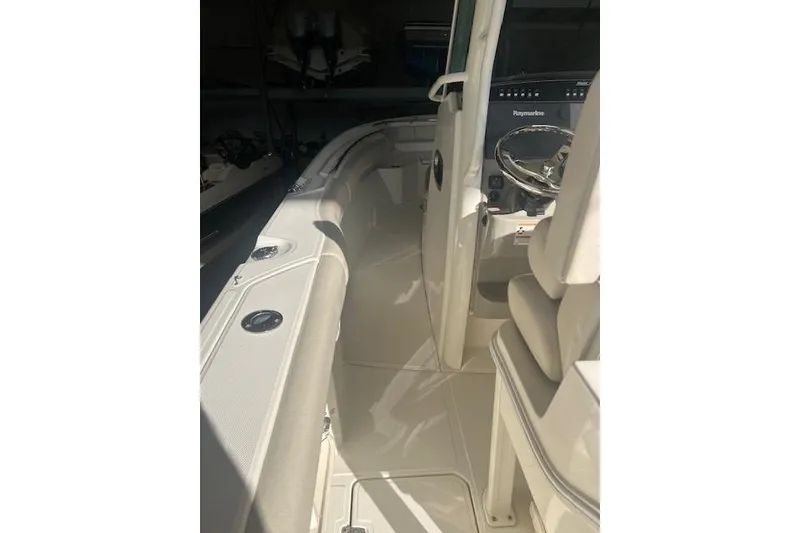 Slide: The Image of 2017 Boston Whaler 280 Outrage in a garage, showcasing dual outboard engines. - 8