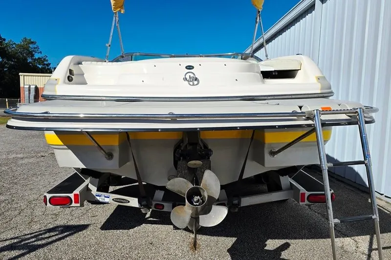 Slide: The Image of 2007 Bryant 219 BR boat on trailer with ladder in a garage setting. - 10