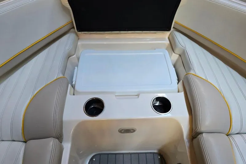 Slide: The Image of 2007 Bryant 219 BR boat interior with beige seating and built-in cup holders. - 23