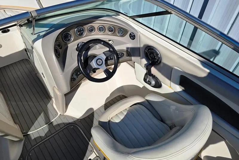 Slide: The Image of 2007 Bryant 219 BR boat cockpit with steering wheel and control panel. - 2