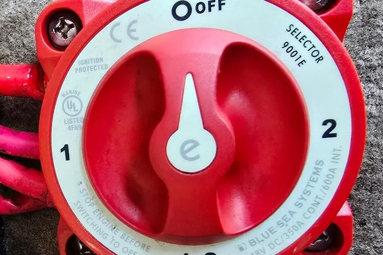 Slide: The Image of Red marine battery selector switch by Blue Sea Systems, model 9001E, with off and numbered positions. - 21