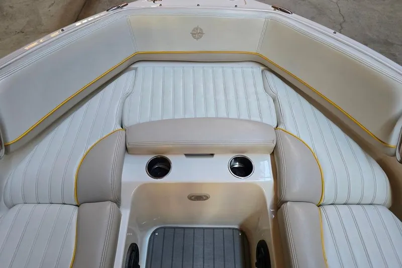 Slide: The Image of 2007 Bryant 219 BR boat interior with beige seating and cup holders. - 22