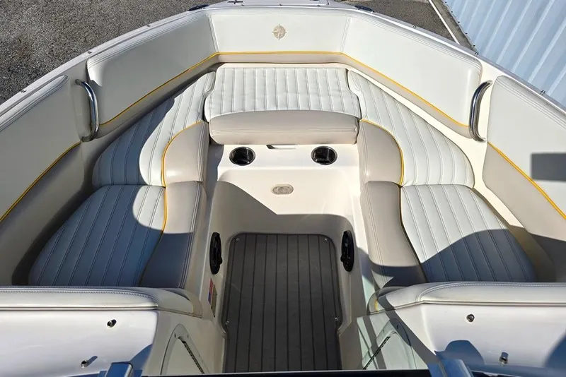 Slide: The Image of 2007 Bryant 219 BR boat interior with white and beige seating, cup holders, and sleek design. - 4