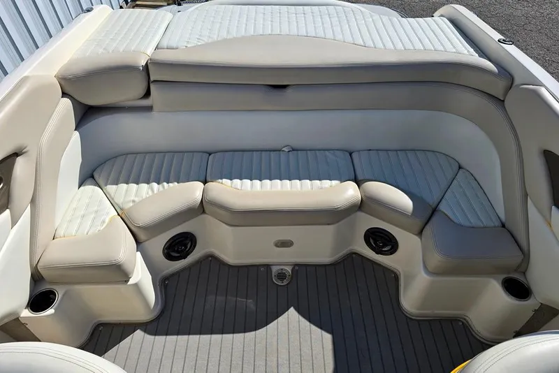 Slide: The Image of 2007 Bryant 219 BR boat interior with cushioned seating and cup holders. - 6