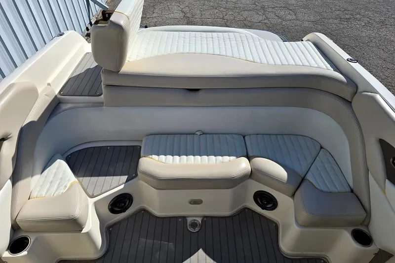 Slide: The Image of Interior seating of a 2007 Bryant 219 BR boat, featuring cushioned seats and cup holders. - 7