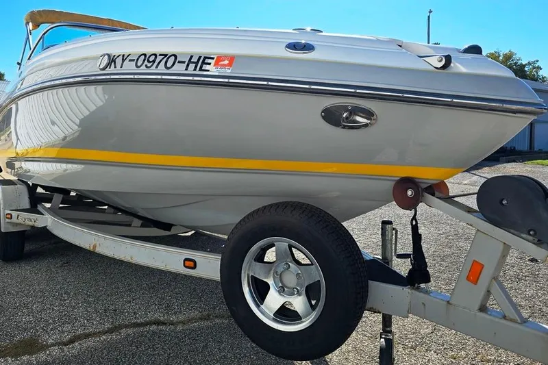 Slide: The Image of 2007 Bryant 219 BR boat on trailer, side view with registration number visible. - 9