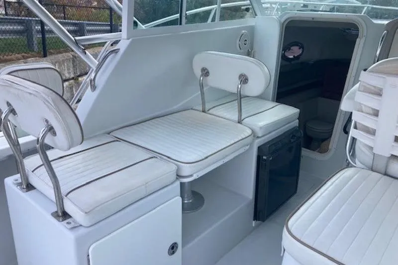 Slide: The Image of Interior of 2008 Glacier Bay 2685 Coastal Runner with white seating and compact cabin. - 10