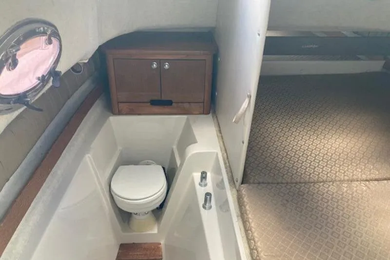 Slide: The Image of 2008 Glacier Bay 2685 Coastal Runner cabin interior with toilet and storage cabinet. - 13