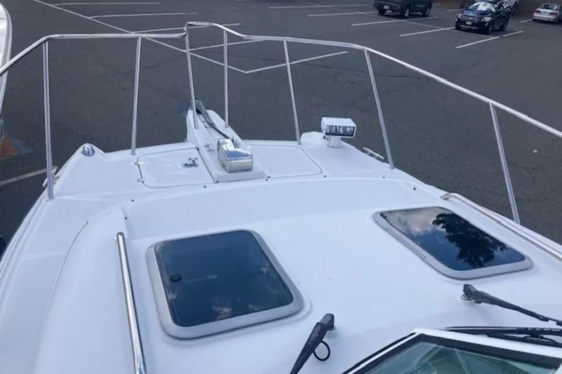 Slide: The Image of 2008 Glacier Bay 2685 Coastal Runner boat deck with hatches, parked in a lot. - 3